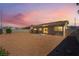Large backyard with a gravel landscape, offering privacy with block wall fencing at 2111 Hollow Oak Ave, North Las Vegas, NV 89031