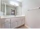Bathroom featuring a single sink vanity with a large mirror and tiled floor at 2111 Hollow Oak Ave, North Las Vegas, NV 89031
