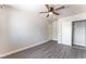 Bedroom featuring wood-look floors, a ceiling fan, and a closet with sliding doors at 2111 Hollow Oak Ave, North Las Vegas, NV 89031