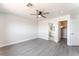 Spacious bedroom featuring wood floors, a ceiling fan, and access to a bathroom and closet at 2111 Hollow Oak Ave, North Las Vegas, NV 89031