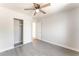 Bedroom featuring wood-look flooring, a ceiling fan, and a closet with sliding doors at 2111 Hollow Oak Ave, North Las Vegas, NV 89031