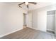 Bedroom featuring wood-look flooring, a ceiling fan, and a closet with sliding doors at 2111 Hollow Oak Ave, North Las Vegas, NV 89031