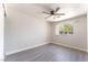 Bedroom with wood-look flooring, ceiling fan, a window, and neutral walls at 2111 Hollow Oak Ave, North Las Vegas, NV 89031