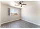 Bedroom with sleek wood-look flooring, a ceiling fan, and a bright window at 2111 Hollow Oak Ave, North Las Vegas, NV 89031