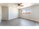 Bedroom featuring wood floors, a ceiling fan, and backyard views at 2111 Hollow Oak Ave, North Las Vegas, NV 89031