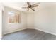 Bedroom with sleek wood-look flooring, a ceiling fan, and a bright window at 2111 Hollow Oak Ave, North Las Vegas, NV 89031