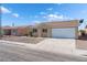 Single-story house with a two-car garage and desert landscaping at 2111 Hollow Oak Ave, North Las Vegas, NV 89031