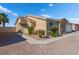 Exterior view of a house featuring desert landscaping and a charming entryway at 2111 Hollow Oak Ave, North Las Vegas, NV 89031