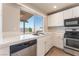 Kitchen showcasing tile countertops, stainless steel appliances, and natural light at 2111 Hollow Oak Ave, North Las Vegas, NV 89031