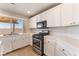 Kitchen with tile countertops, stainless steel appliances, and backyard views at 2111 Hollow Oak Ave, North Las Vegas, NV 89031