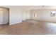 Bright and spacious living room featuring tile floors and natural light through several windows at 2111 Hollow Oak Ave, North Las Vegas, NV 89031