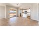 Bright living area featuring tile floors, connecting the kitchen and backyard access at 2111 Hollow Oak Ave, North Las Vegas, NV 89031