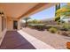 A covered back patio with desert landscaping and privacy wall at 2131 Waterton Rivers Dr, Henderson, NV 89044
