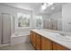 Bathroom featuring double sinks, soaking tub, and a separate shower at 2131 Waterton Rivers Dr, Henderson, NV 89044
