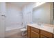 Bathroom featuring a tub-shower combo, single vanity, and tile flooring at 2131 Waterton Rivers Dr, Henderson, NV 89044