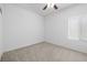 Carpeted bedroom features a ceiling fan and a window at 2131 Waterton Rivers Dr, Henderson, NV 89044
