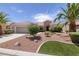 Charming single-story home featuring a well-maintained yard with desert landscaping and palm trees at 2131 Waterton Rivers Dr, Henderson, NV 89044