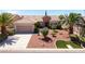 Charming single-story home with desert landscaping and palm trees on a sunny day at 2131 Waterton Rivers Dr, Henderson, NV 89044