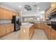 Open concept kitchen with stainless steel appliances, an island, and ample counter space at 2131 Waterton Rivers Dr, Henderson, NV 89044