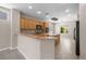 A well lit kitchen with tile floors, bar top and modern appliances at 2131 Waterton Rivers Dr, Henderson, NV 89044