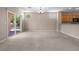 Large living room with sliding door to patio, backyard view and adjacent kitchen at 2131 Waterton Rivers Dr, Henderson, NV 89044