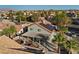 A home featuring solar panels and a backyard patio in a desert landscape at 2204 W San Miguel Ave, North Las Vegas, NV 89032