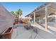 Backyard featuring concrete pavers, a deck, fire pit, and a covered patio at 2204 W San Miguel Ave, North Las Vegas, NV 89032