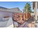 Backyard featuring a quaint deck with decorative rope railings and a walkway at 2204 W San Miguel Ave, North Las Vegas, NV 89032
