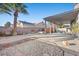 Backyard featuring a gravel area, concrete patio, and covered area with seating at 2204 W San Miguel Ave, North Las Vegas, NV 89032