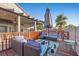 Backyard deck with patio furniture beneath a covered patio and palm tree at 2204 W San Miguel Ave, North Las Vegas, NV 89032