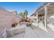 Backyard featuring concrete pavers, a deck, fire pit, and a covered patio at 2204 W San Miguel Ave, North Las Vegas, NV 89032