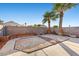 Backyard featuring decorative gravel area, concrete pavers, and mature palm trees at 2204 W San Miguel Ave, North Las Vegas, NV 89032