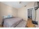 Bedroom with bed, ottoman, TV, and doorway leading to an adjacent room at 2204 W San Miguel Ave, North Las Vegas, NV 89032