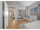 Bright bedroom with hardwood floors, mirrored closet, and connected bath and bedroom at 2204 W San Miguel Ave, North Las Vegas, NV 89032
