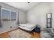 Minimalist bedroom with a bed, window, and a comfortable beanbag chair at 2204 W San Miguel Ave, North Las Vegas, NV 89032