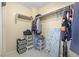 Well-organized walk-in closet features hanging clothes and personal items at 2204 W San Miguel Ave, North Las Vegas, NV 89032
