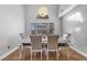 Open dining room boasts natural light, a modern chandelier, and seating for six at 2204 W San Miguel Ave, North Las Vegas, NV 89032
