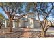 Two-story home with mature trees, a red tile roof, and a well-maintained front yard at 2204 W San Miguel Ave, North Las Vegas, NV 89032