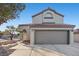 Charming stucco two-story home featuring a red tile roof and a two-car garage at 2204 W San Miguel Ave, North Las Vegas, NV 89032