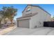 Two-story stucco home with red tile roof, spacious driveway, and a two-car garage at 2204 W San Miguel Ave, North Las Vegas, NV 89032