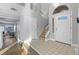 Bright foyer with tile floor, staircase, and natural light from the front door at 2204 W San Miguel Ave, North Las Vegas, NV 89032