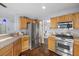 Bright kitchen featuring stainless steel appliances and natural wood cabinets at 2204 W San Miguel Ave, North Las Vegas, NV 89032