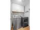 Laundry room with full size washer, dryer, and upper cabinets at 2204 W San Miguel Ave, North Las Vegas, NV 89032