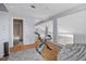 Open loft with hardwood floors, exercise bike, and adjacent bathroom and balcony at 2204 W San Miguel Ave, North Las Vegas, NV 89032