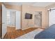 Bright main bedroom with hard surface floors, access to the bathroom and a view of the backyard at 2204 W San Miguel Ave, North Las Vegas, NV 89032