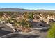 Expansive view of a neighborhood featuring single-Gathering homes, lush landscaping, and scenic mountain backdrop on a clear day at 2204 W San Miguel Ave, North Las Vegas, NV 89032