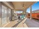 Covered patio with ceiling fan, seating area, and views of the backyard at 2204 W San Miguel Ave, North Las Vegas, NV 89032