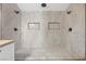 Luxurious walk-in shower features dual shower heads, marble tile surround, and two recessed shower caddies at 2204 W San Miguel Ave, North Las Vegas, NV 89032