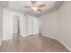 Spacious bedroom with neutral paint, tile floors, ceiling fan, and access to the bathroom and closet at 224 Morgyn Ln # 6, Boulder City, NV 89005