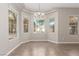 Bright dining area featuring a tray ceiling and large windows at 224 Morgyn Ln # 6, Boulder City, NV 89005